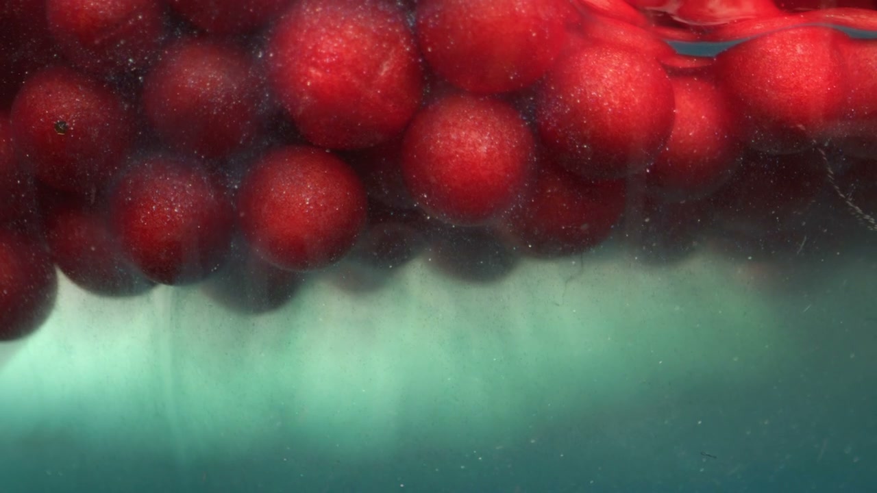 Red Spheres Floating on Water Surface