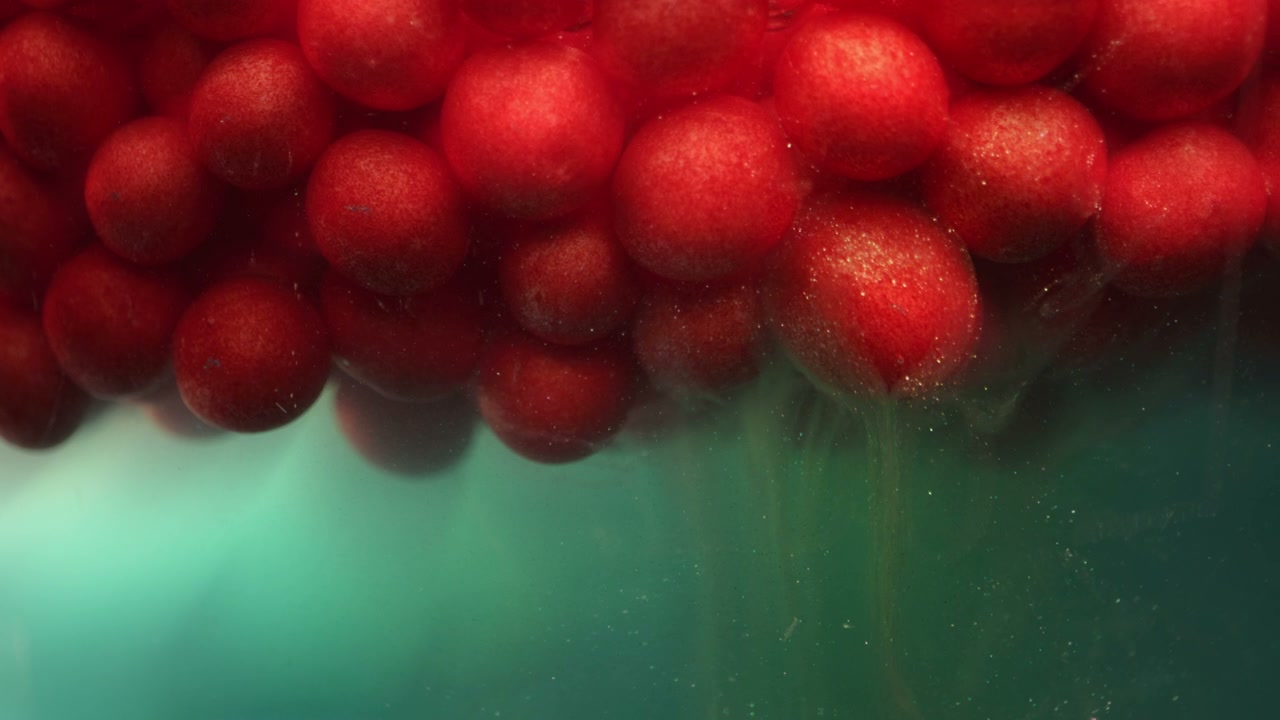Red Spheres Submerged in Green Liquid