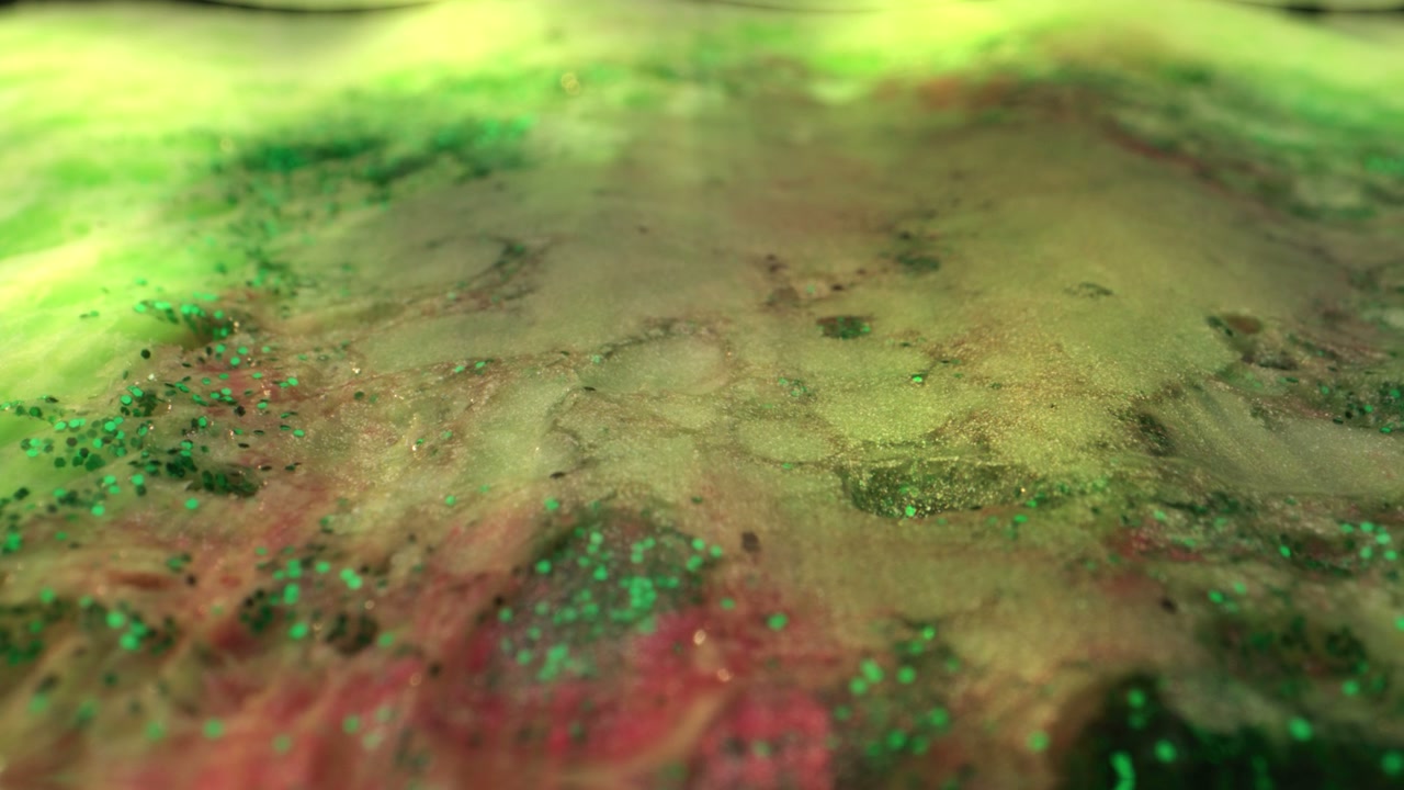 Shimmering Green and Red Organic Liquid Texture