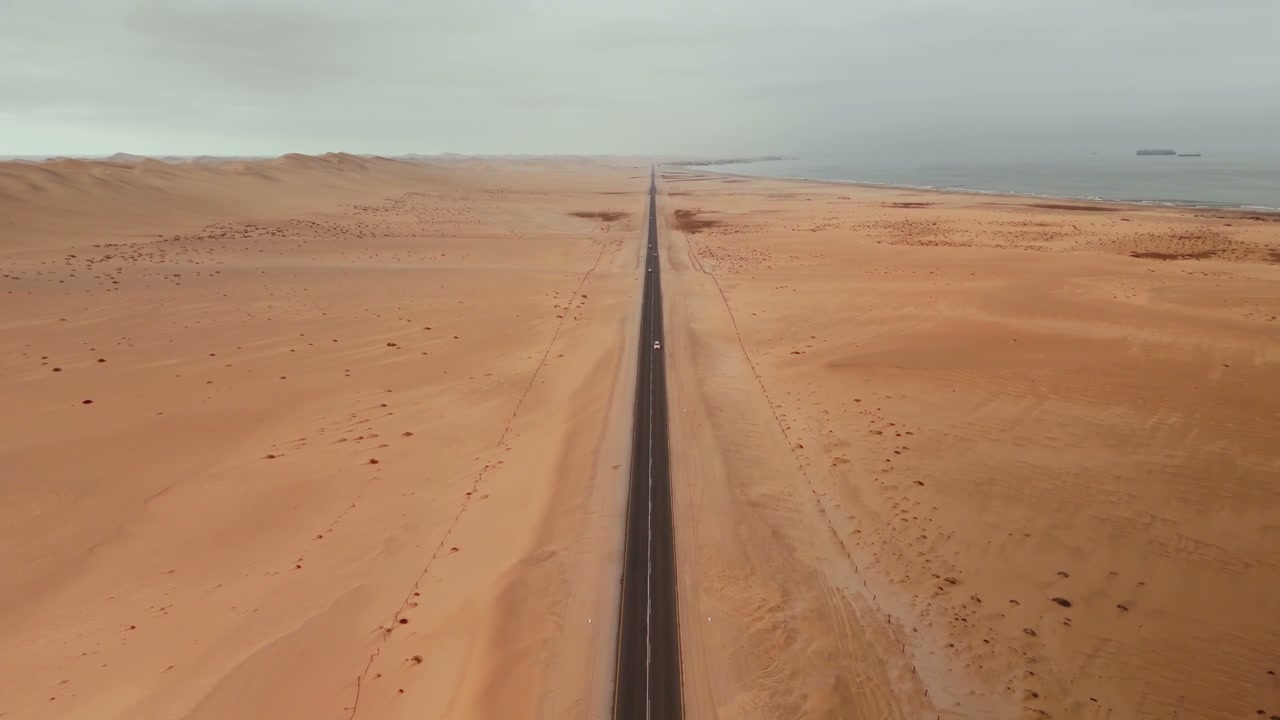 Car on Desert Road Towards Ocean