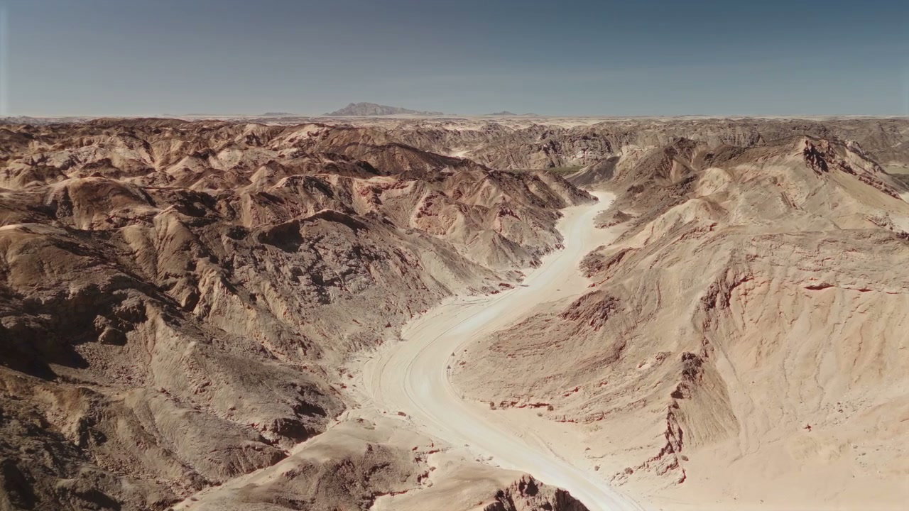 Sweeping Desert Landscape with Dry Riverbed