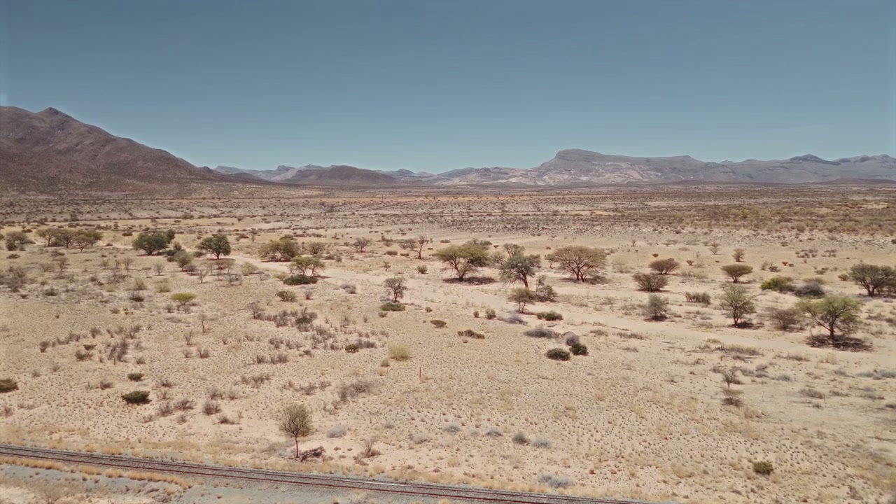 Desert Landscape with Railway and Mountains