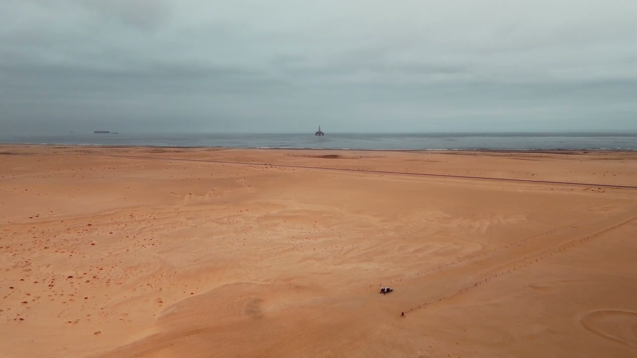 Desert Coastline With Offshore Oil Rig