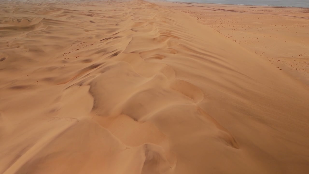 Aerial View of Desert Dunes Meeting Ocean