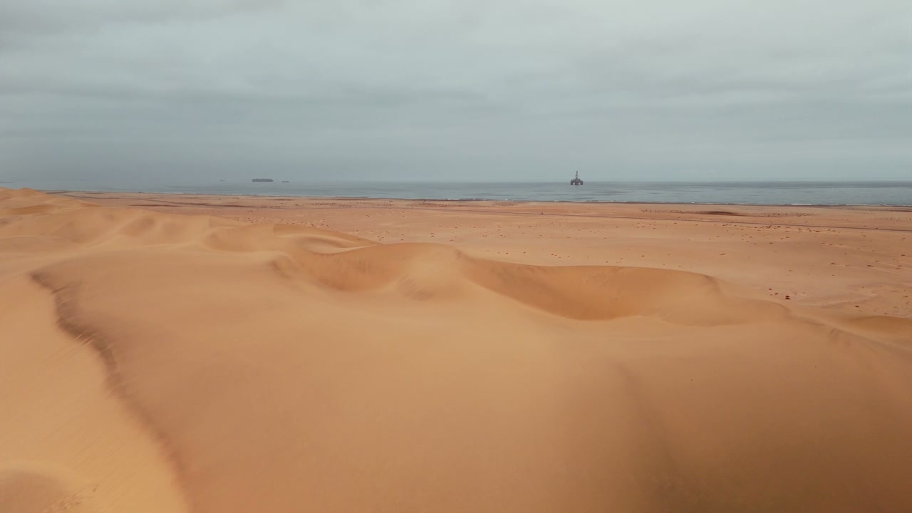 Desert Dunes and Ocean with Offshore Platform