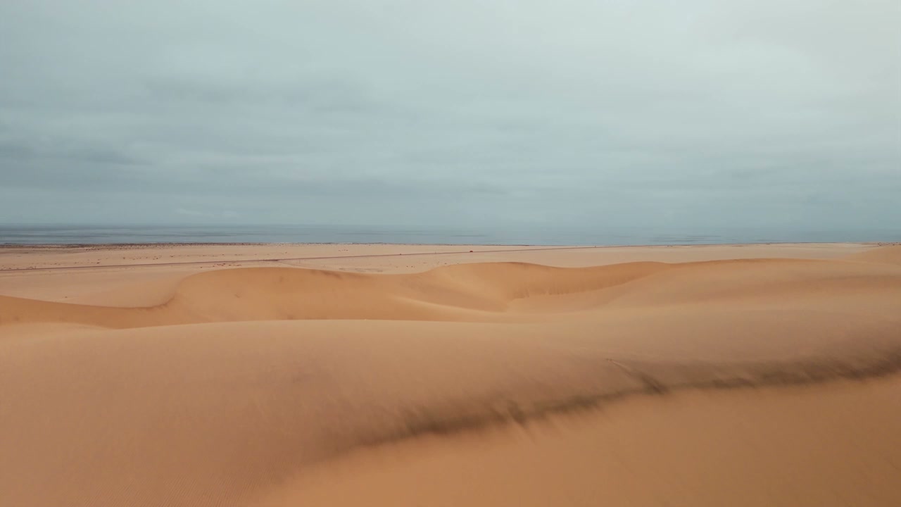 Drone Pullback Over Desert Dunes