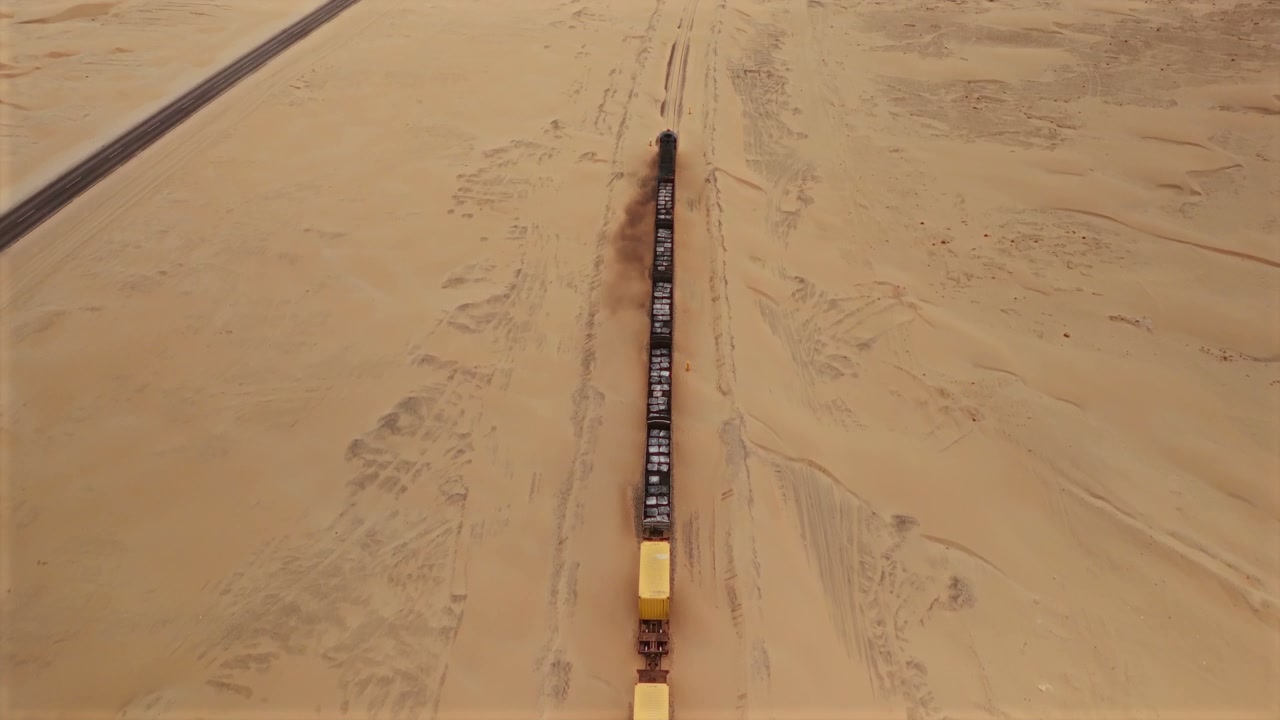 Long Cargo Train Moving Through Desert