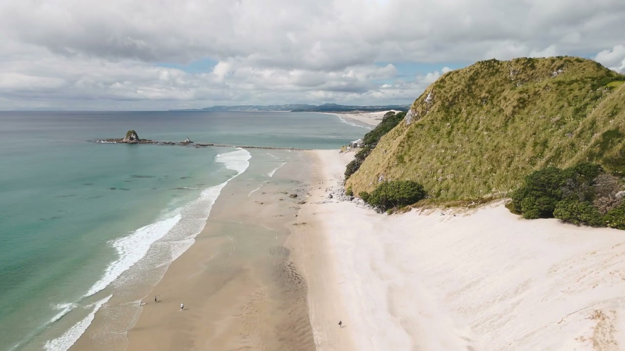 Scenic New Zealand Coastline with Beach and Hills