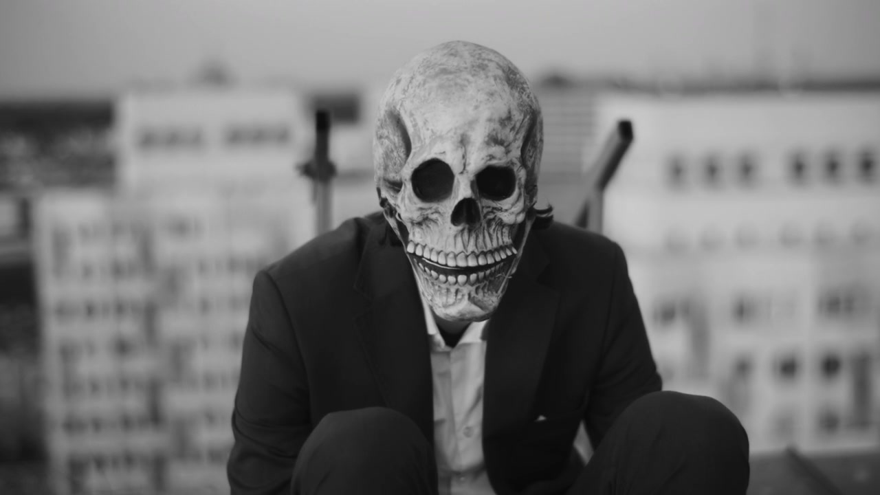 Person in Skull Mask on City Rooftop