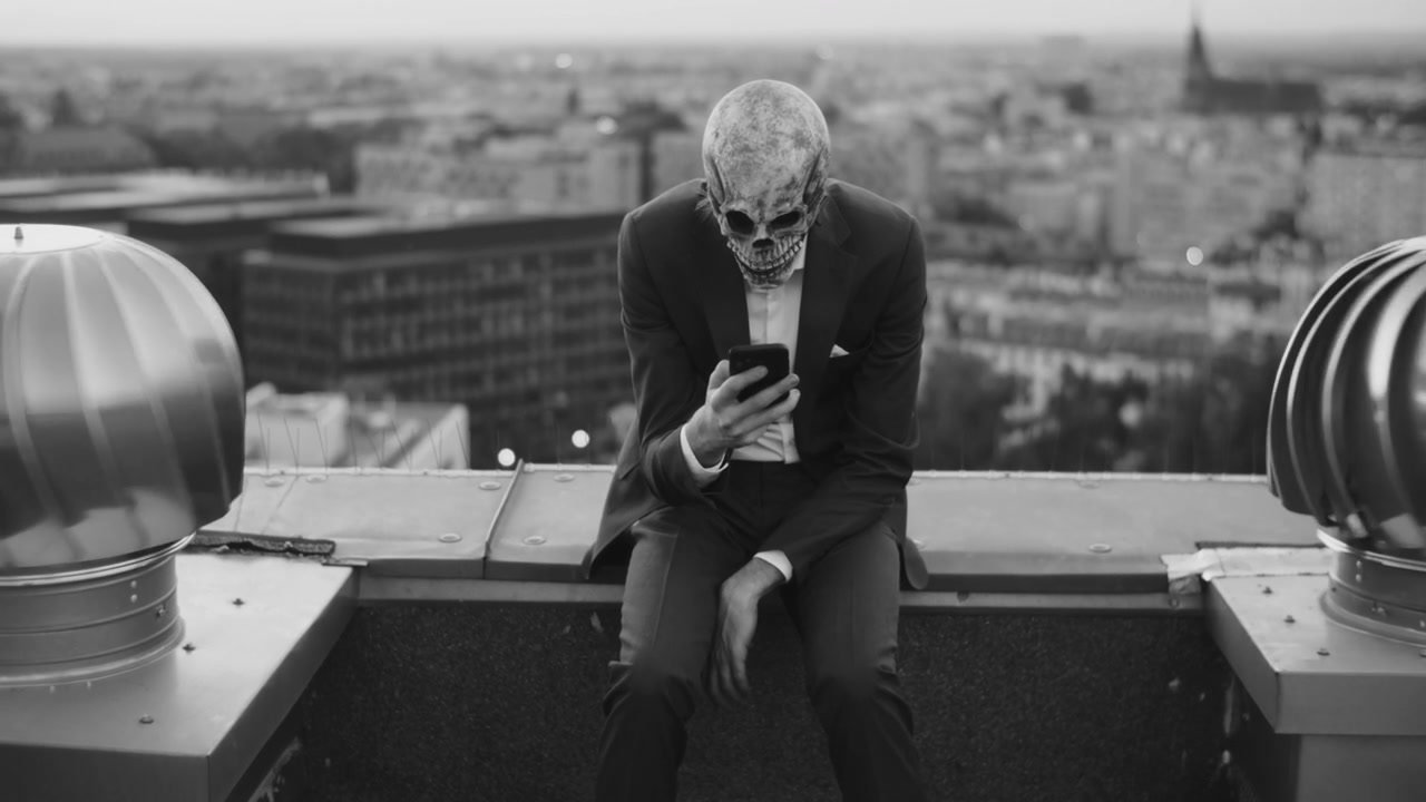 Skeleton Mask Man on Rooftop Using Phone