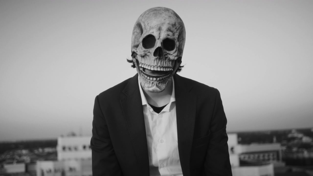 Person in Skull Mask on Rooftop
