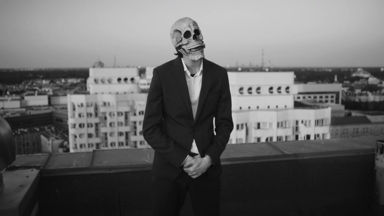Person in Skull Mask on Rooftop
