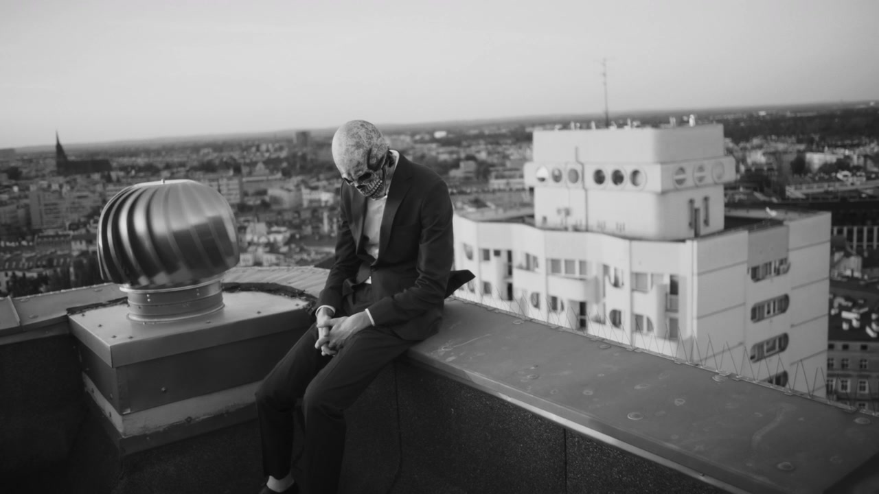 Person in Skeleton Mask on City Rooftop