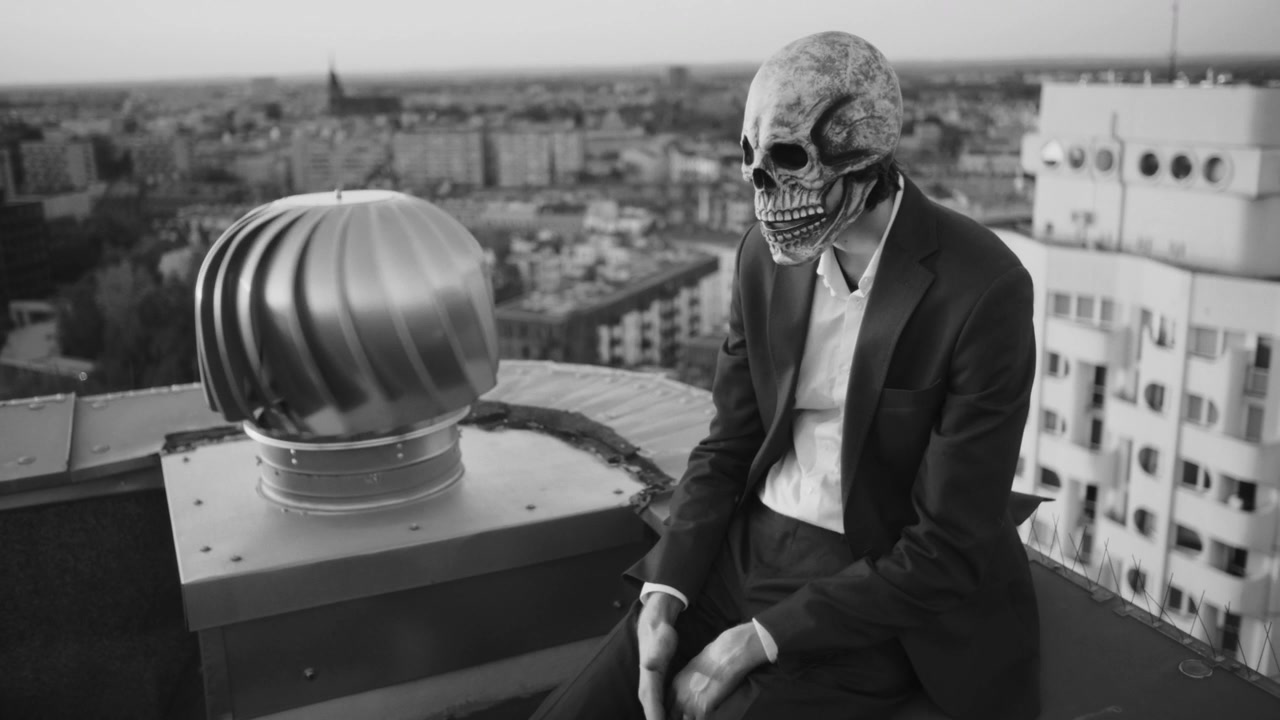 Man in Skull Mask on City Rooftop