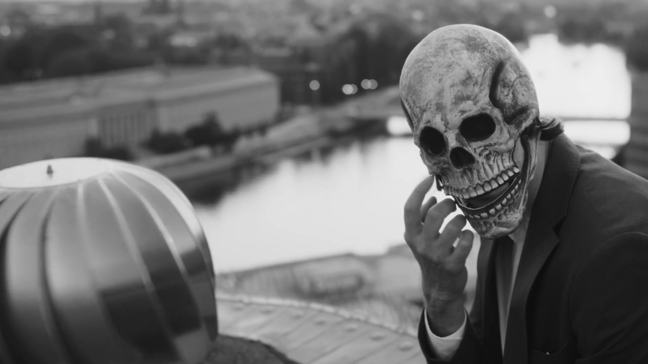 Skull Mask Figure on City Rooftop