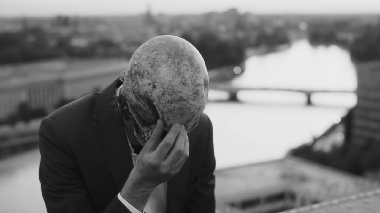 Person in Skull Mask on City Rooftop