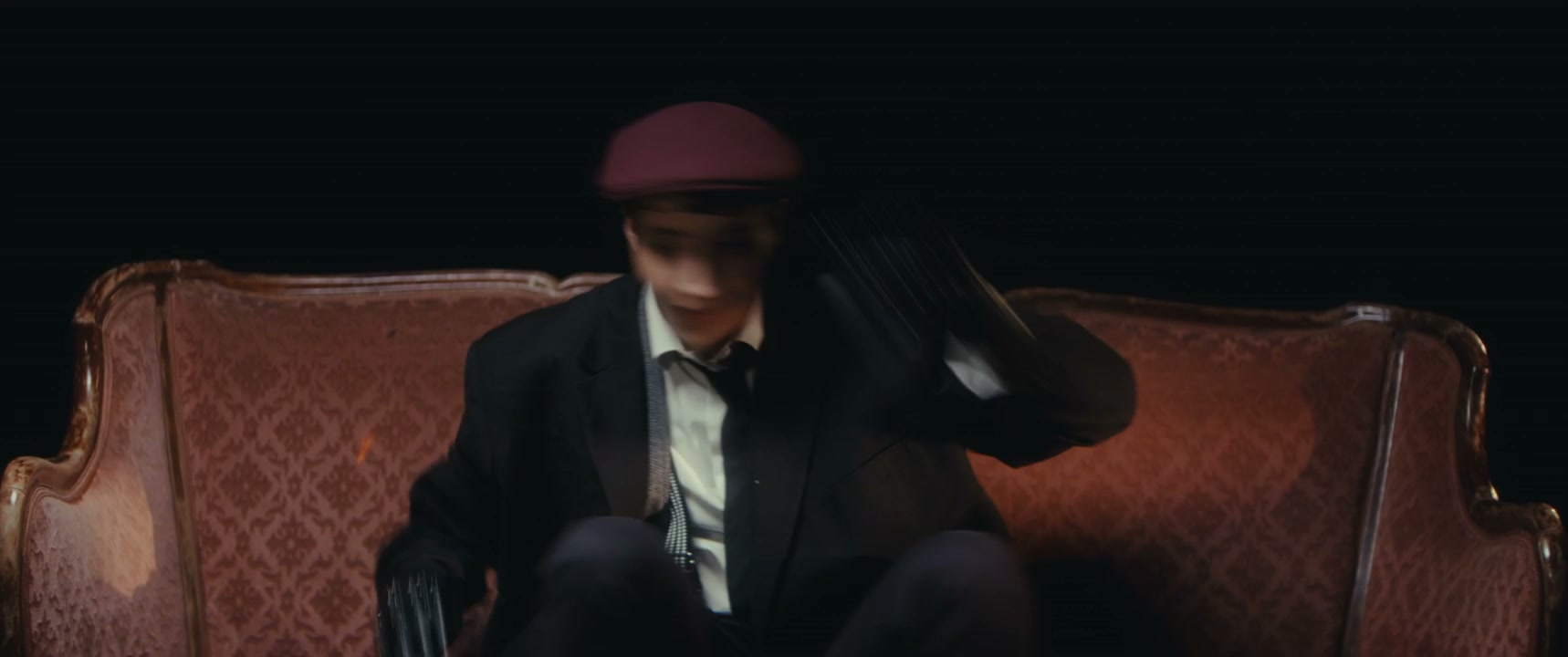 Mime Artist Performing Playfully on Sofa