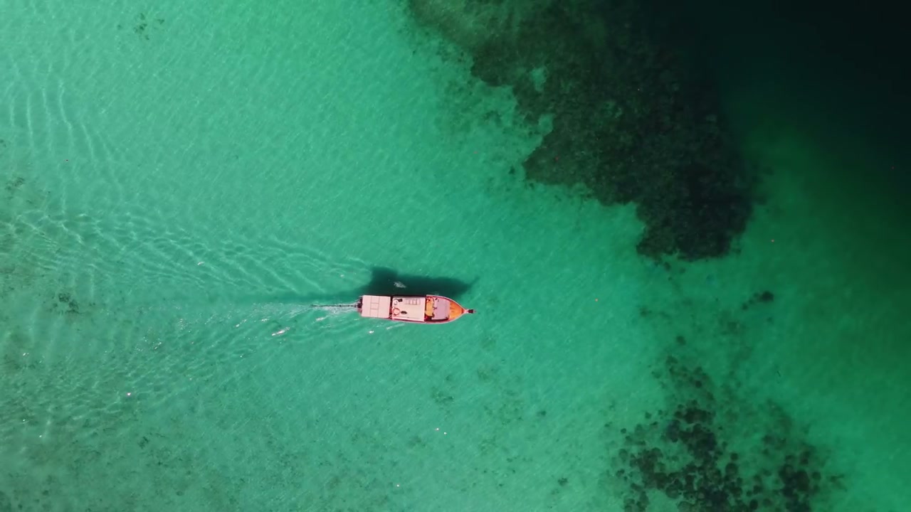 Top-Down View of Boat in Azure Water