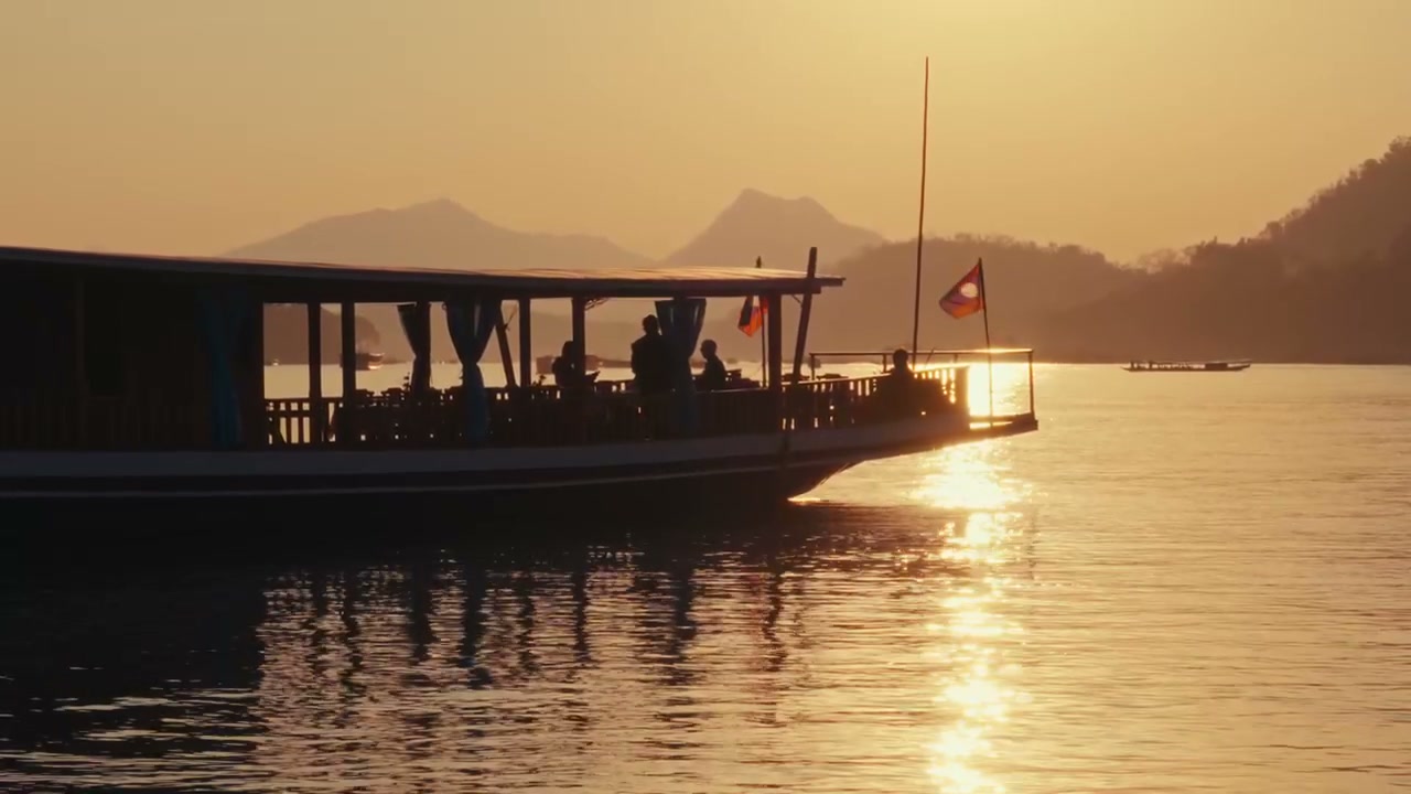 Boat Cruising Mekong River at Sunset
