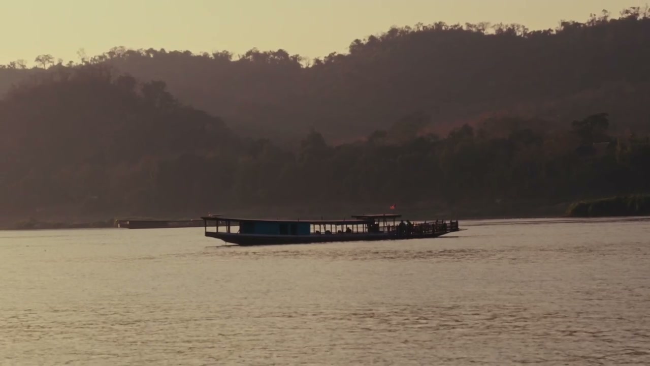 Boat Moving on Mekong River at Sunset