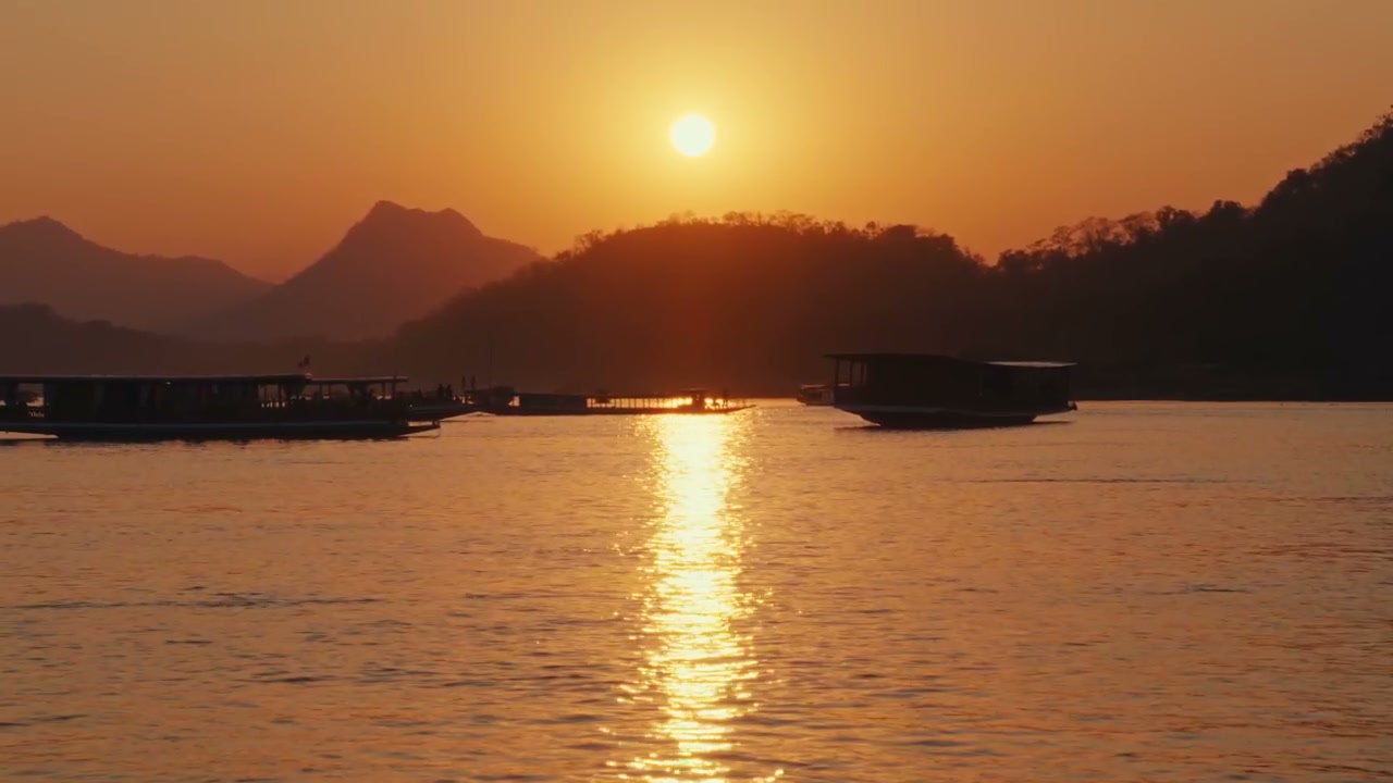 Mekong River Sunset with Boats and Mountains