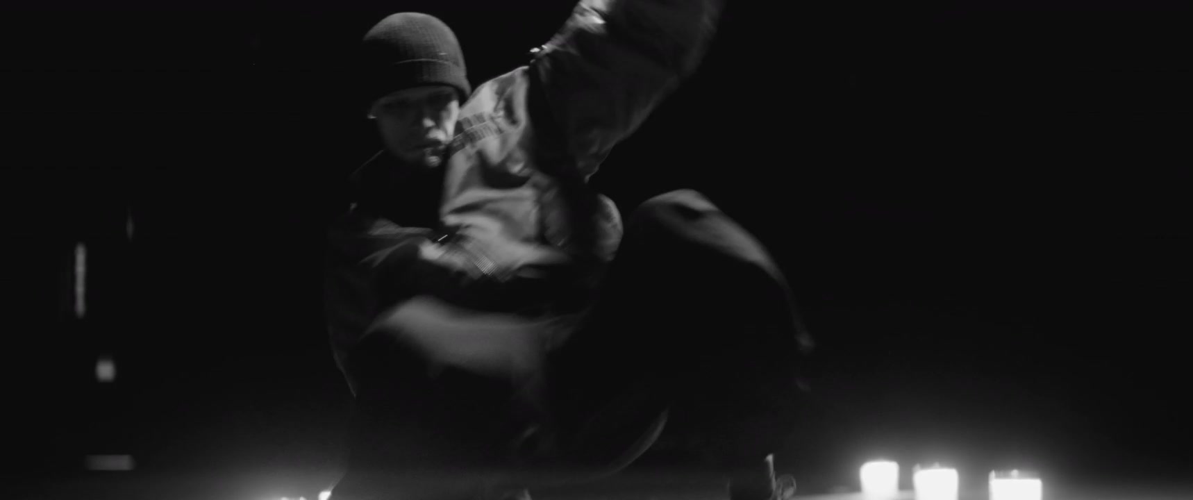 Man Breakdancing on Dark Stage