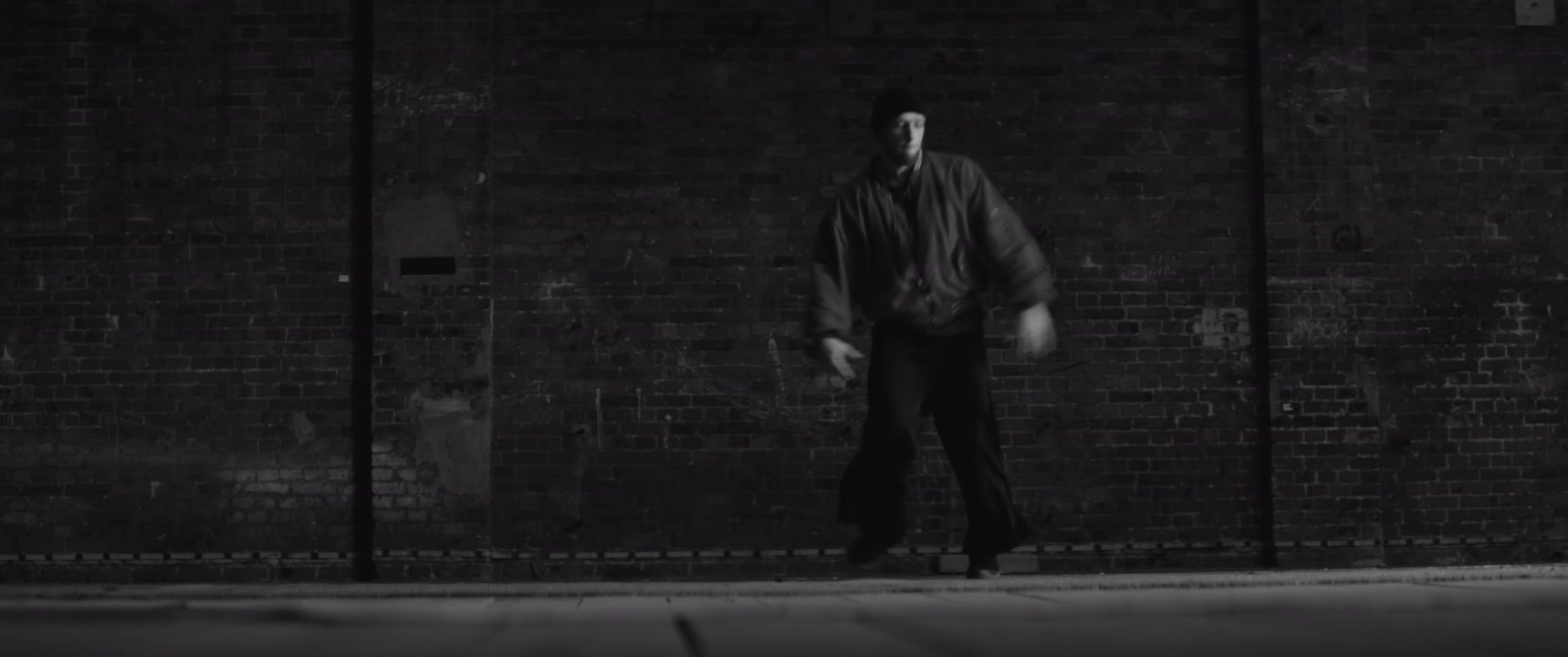 Breakdancer Performing in Dark Warehouse