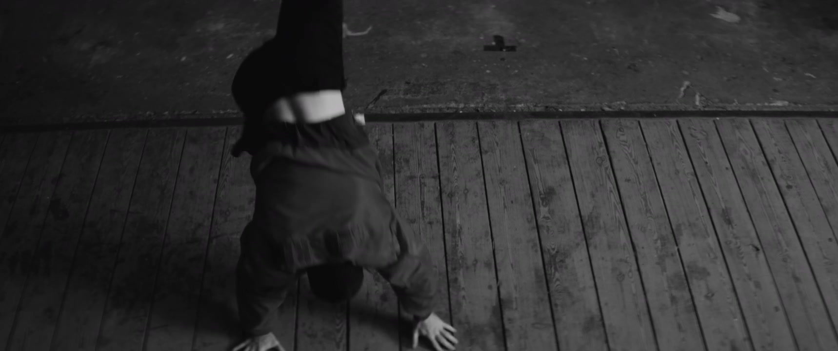Breakdancer Performing on Wooden Floor