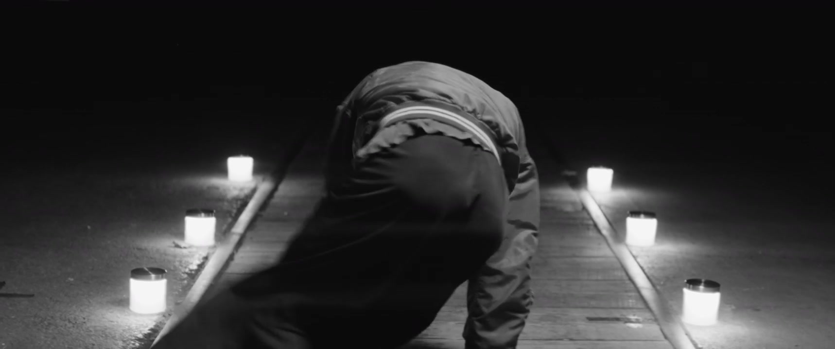 Breakdancer Performing Moves on a Lit Path at Night