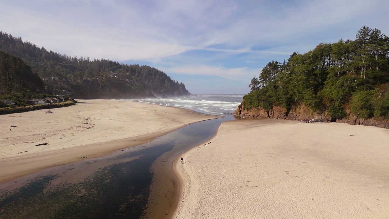 River Flowing to Pacific Ocean on Sandy Beach
