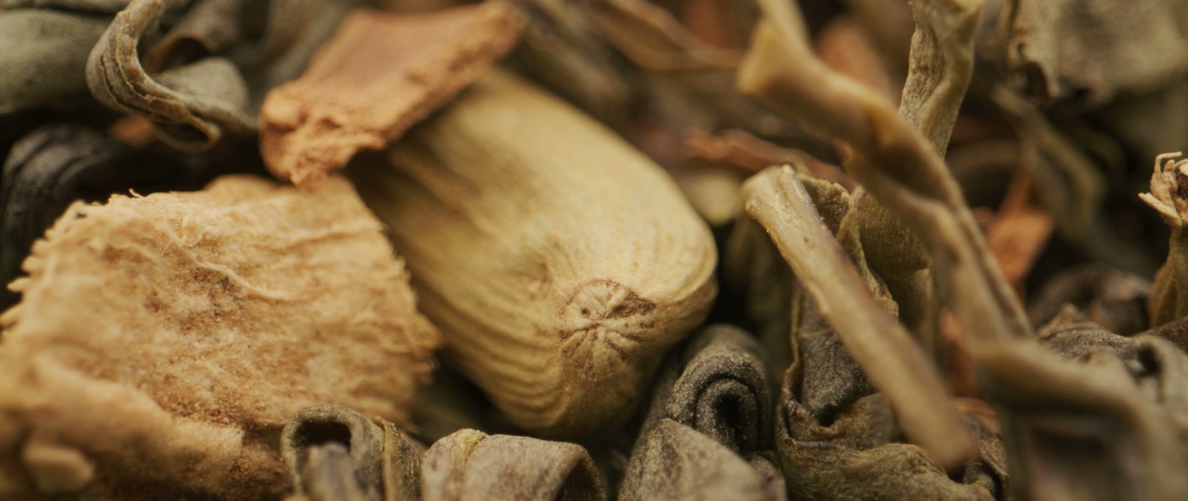 Close Up of Dried Green Tea, Ginger, and Cardamom
