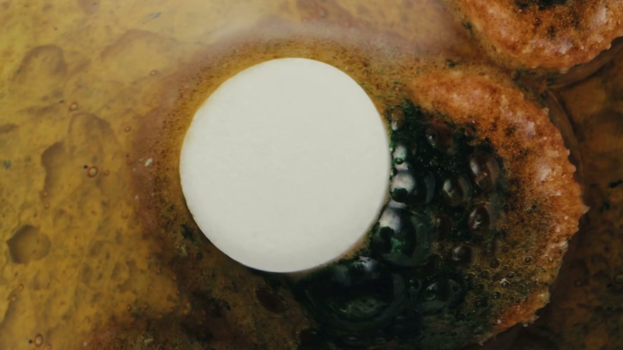 Pill Dissolving in Colorful Liquid