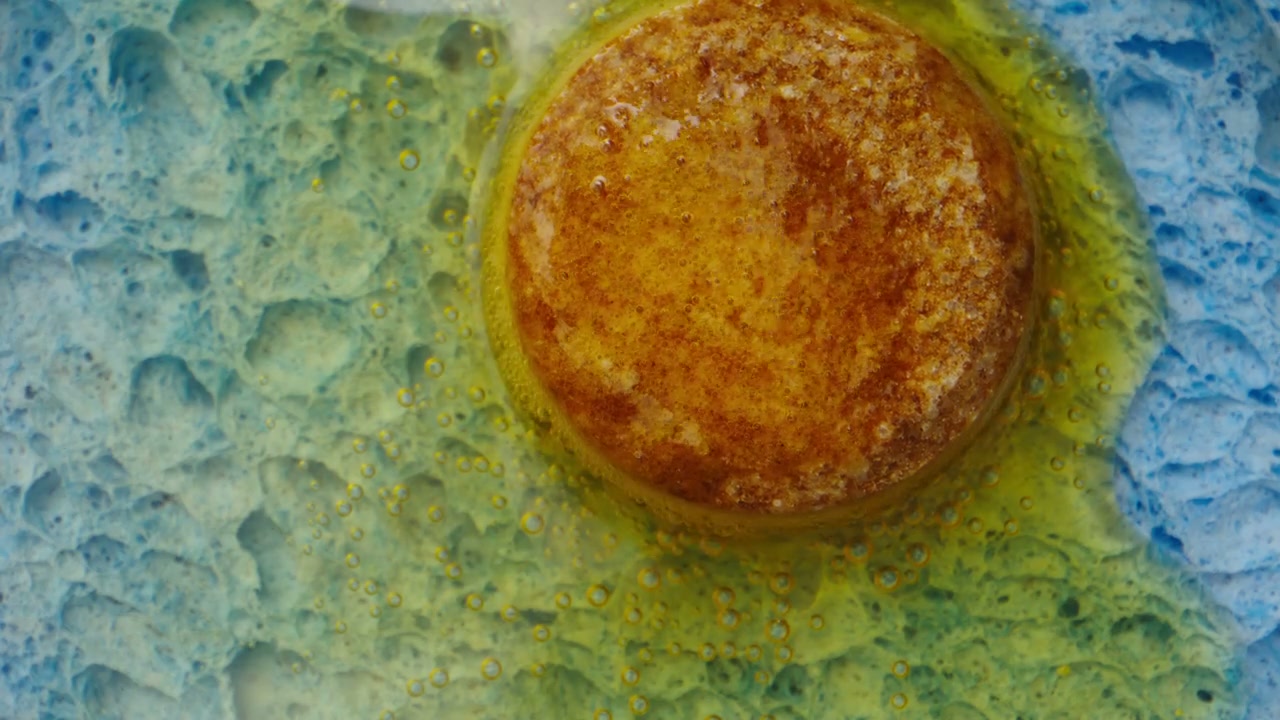 Effervescent Tablet Dissolving in Colorful Liquid