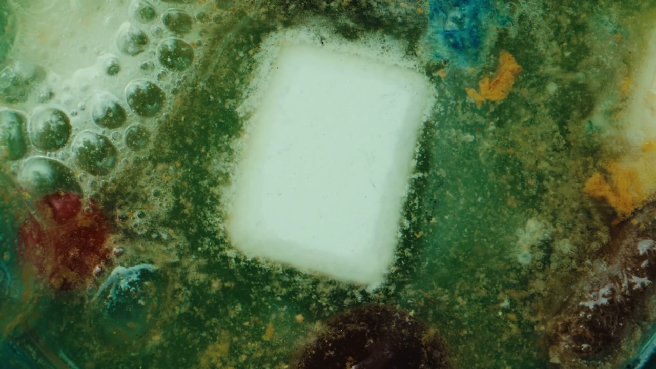 Dissolving Tablet in Colorful Liquid