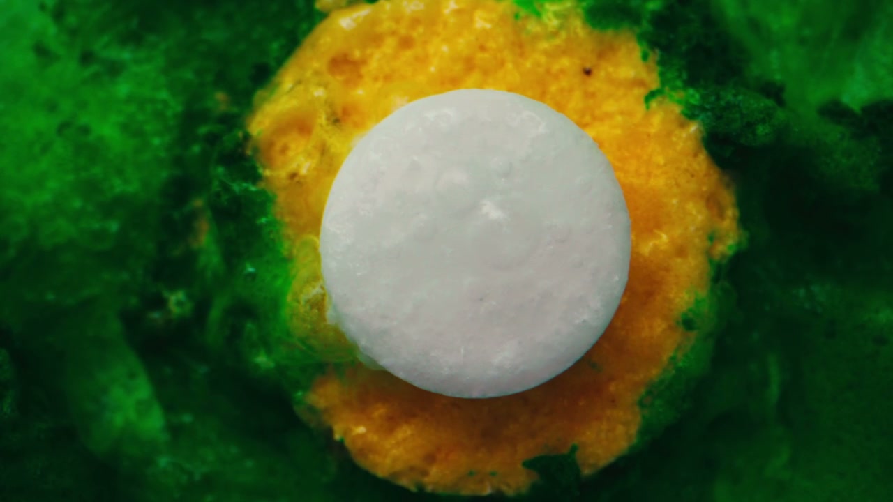 Fizzy Tablet Dissolving on Colorful Surface