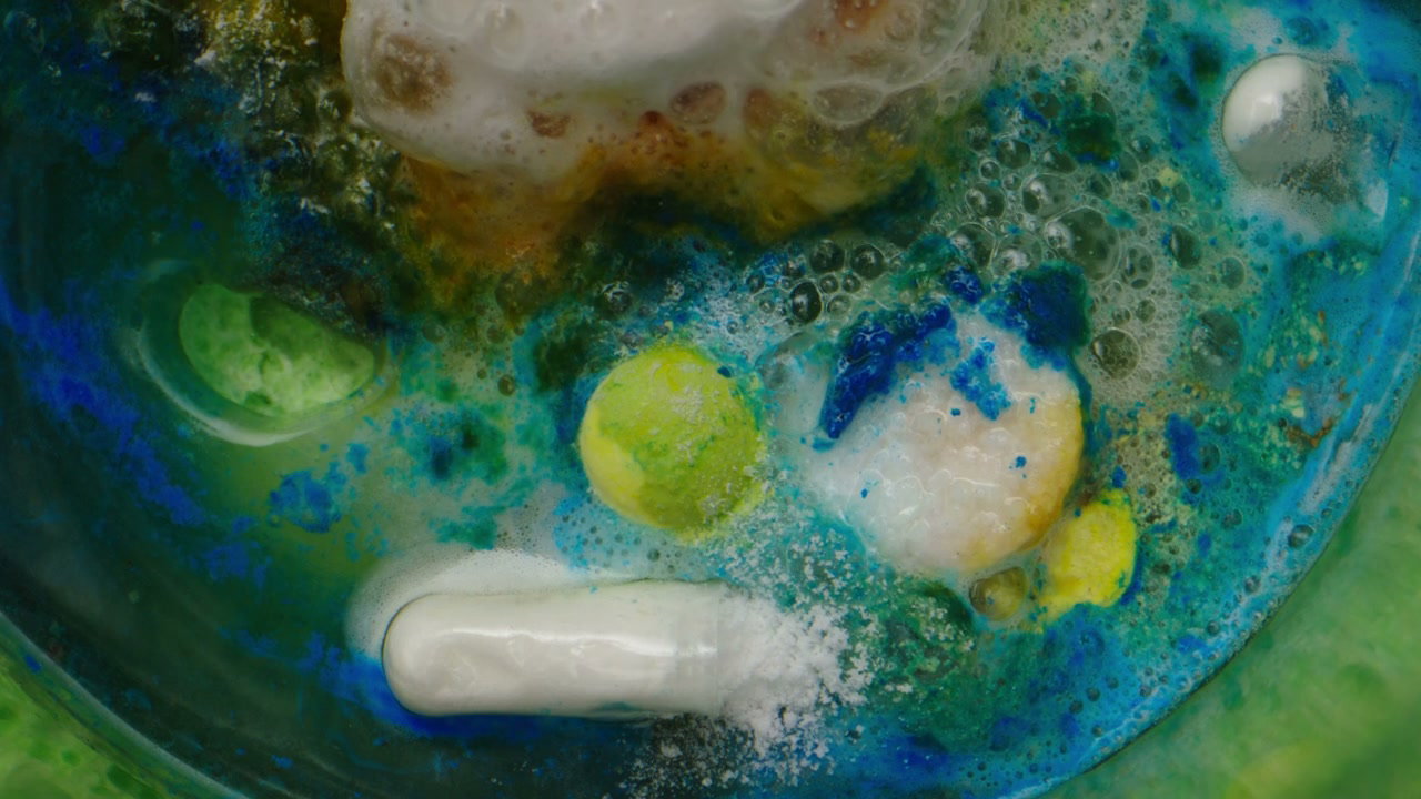 Colorful Pills Dissolving into Vibrant Foam