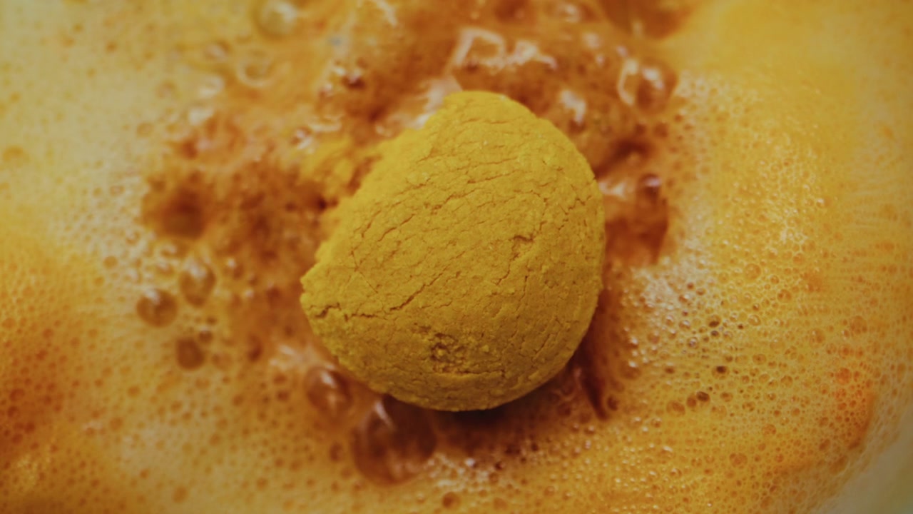 Yellow Tablet Dissolving in Orange Foam