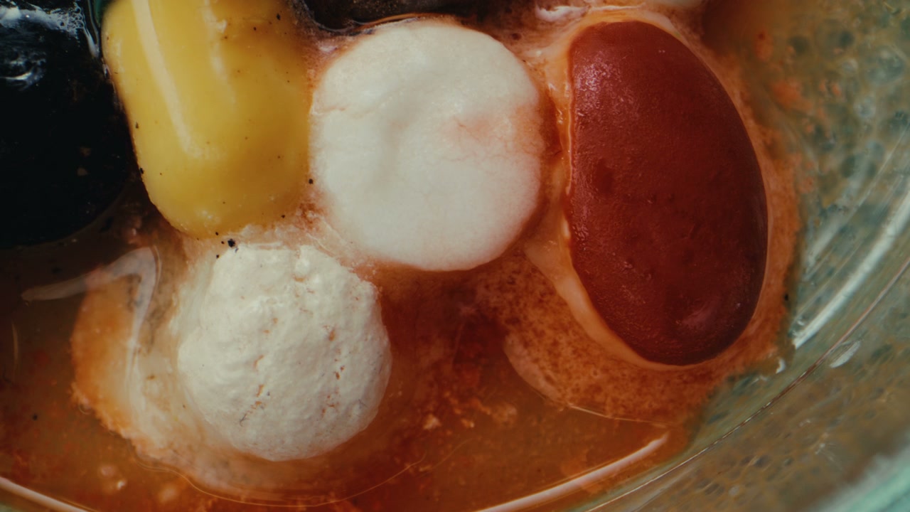 Colorful Tablets Reacting in Liquid