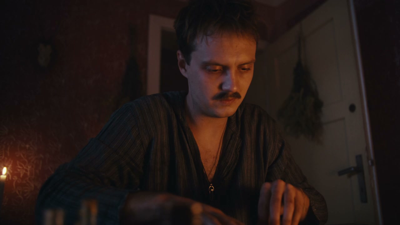 Man Performing Ritual by Candlelight