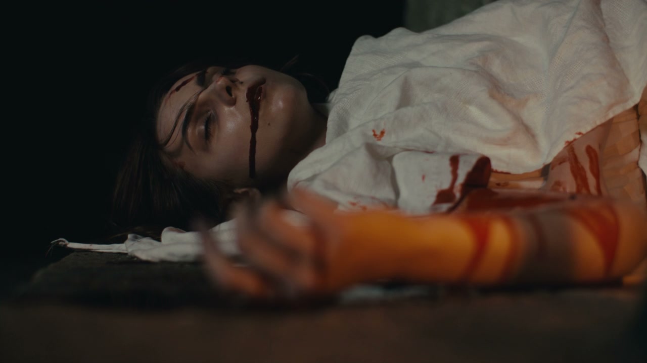 Bloody Victim Lying on Dark Ground