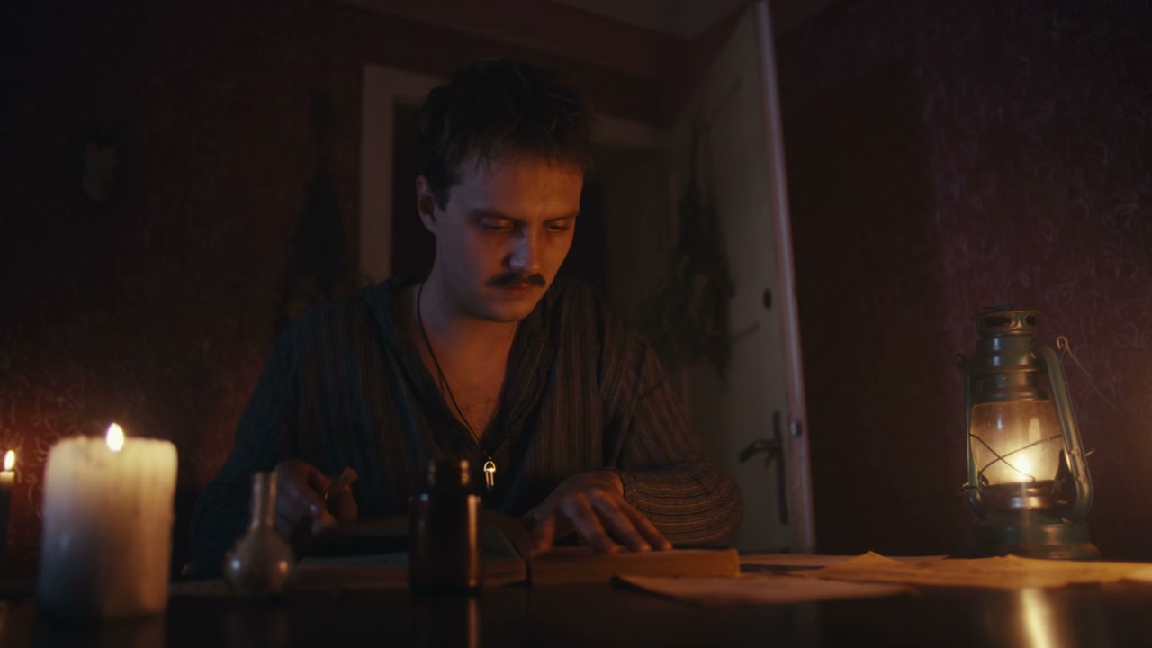Man Studying Ancient Books by Candlelight