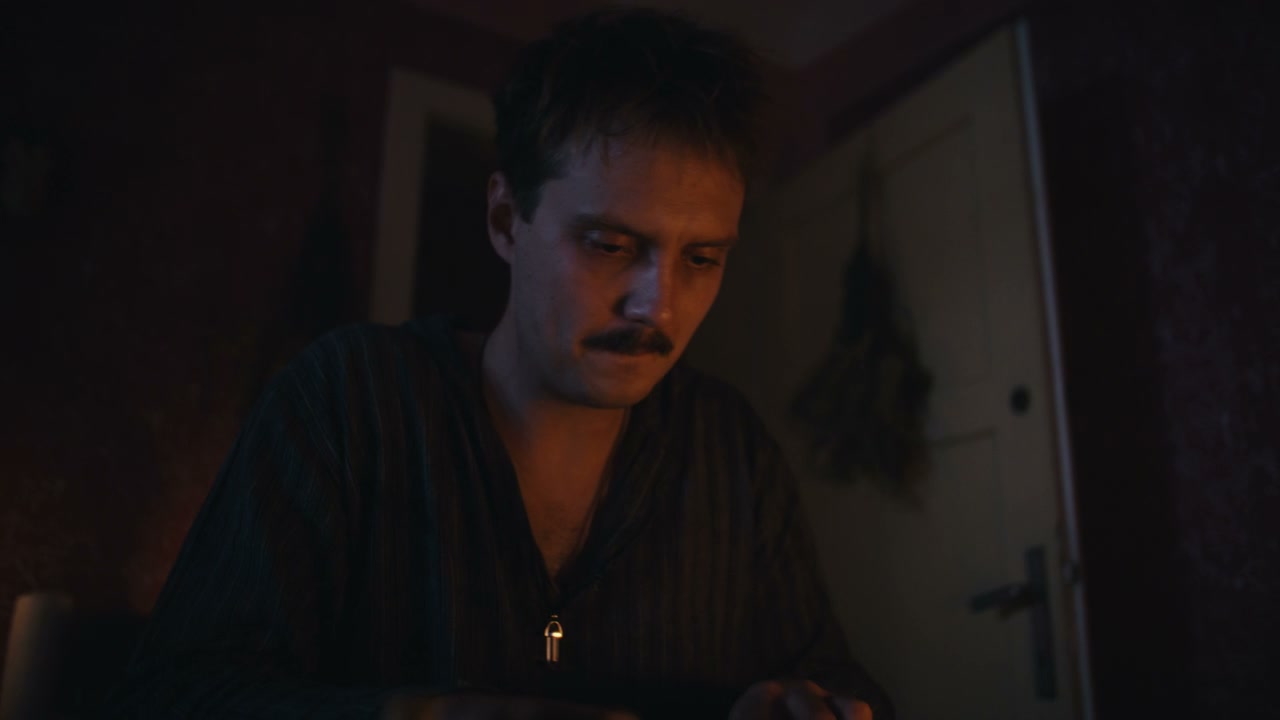 Man Studying Ritual Book by Candlelight