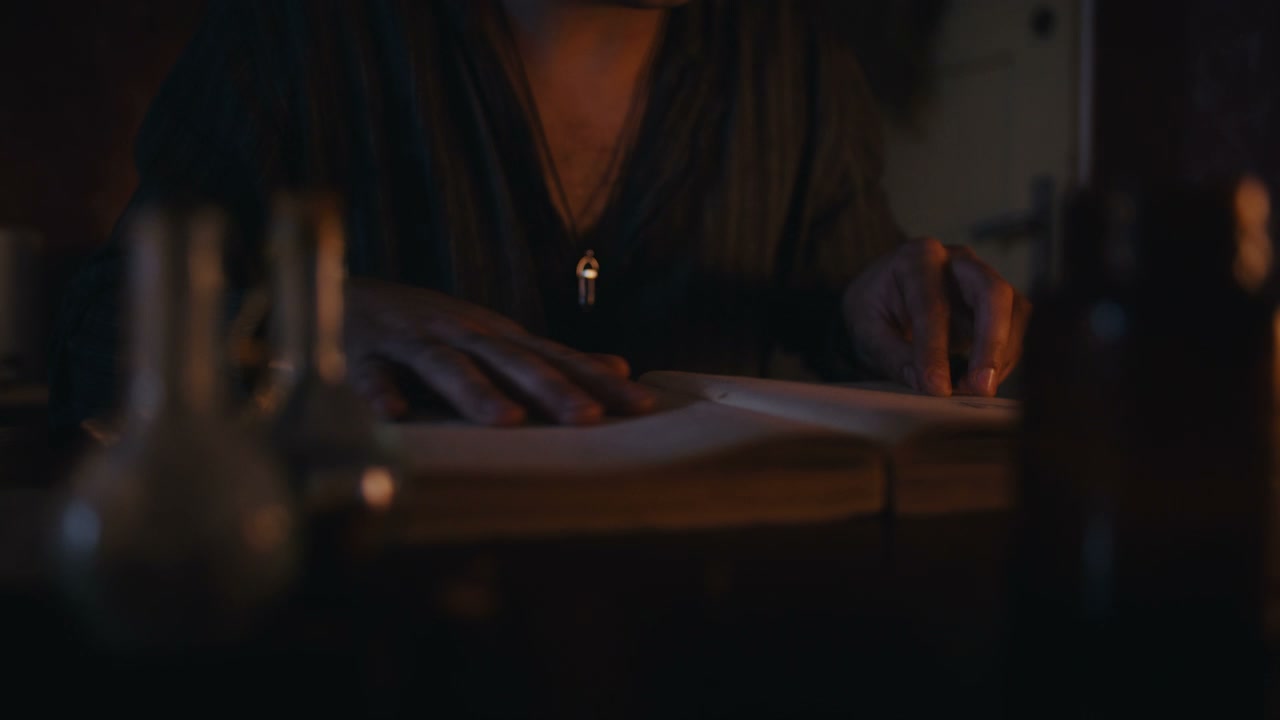 Mysterious Figure Reading Ancient Book