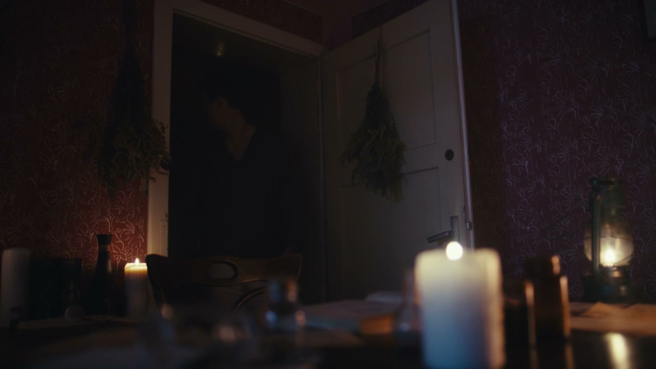 Man Performing Ritual by Candlelight