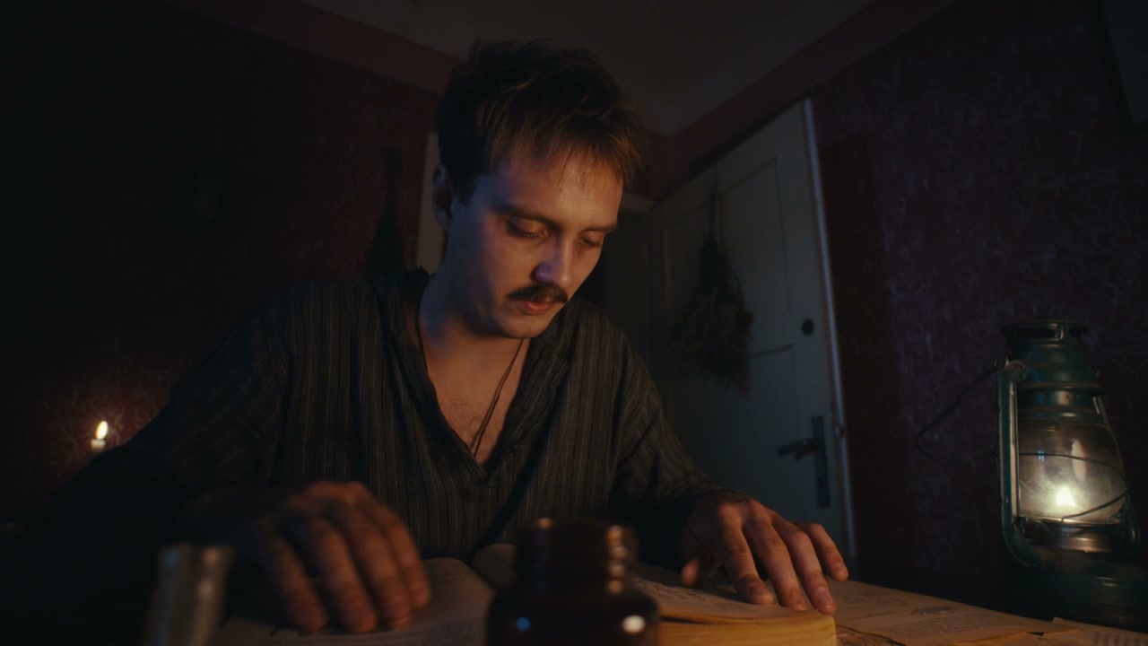 Man Reading Ancient Book by Lamplight