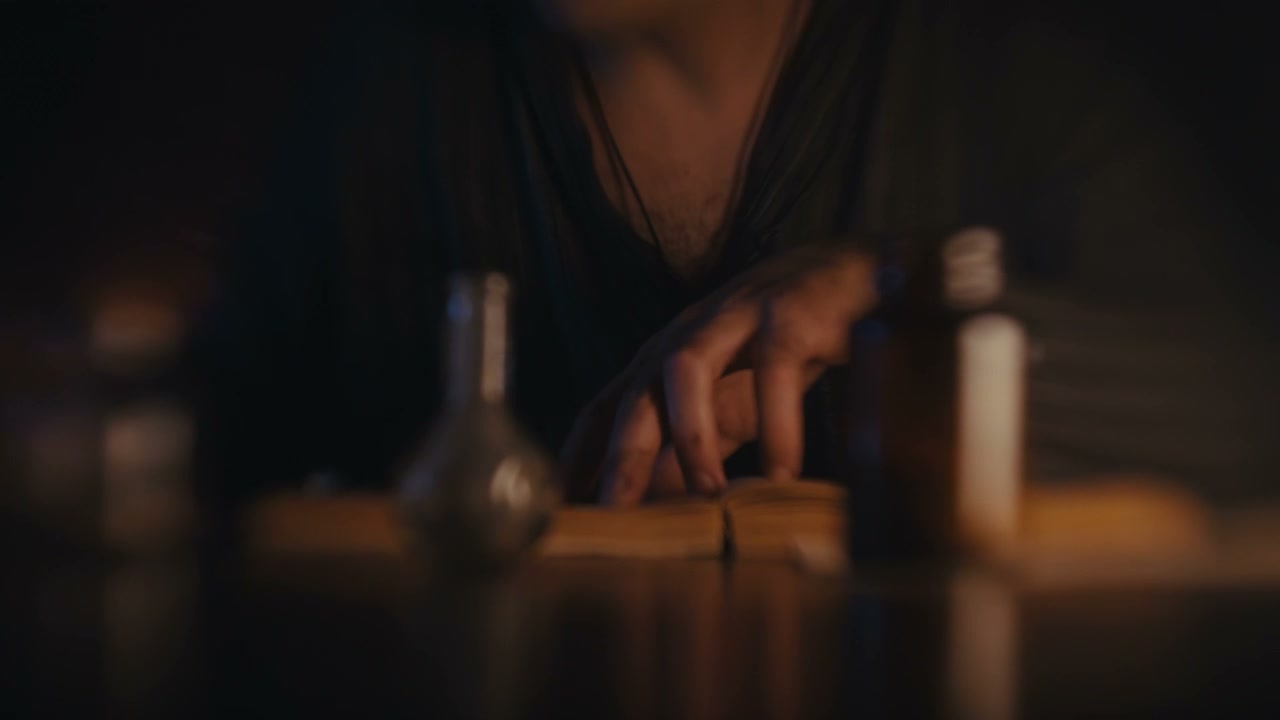 Hands Studying Ancient Book and Scrolls