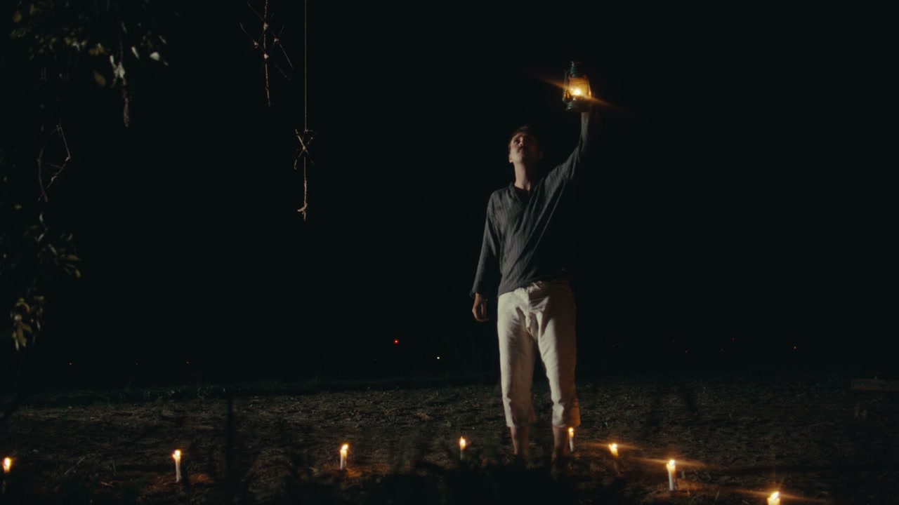 Person Holding Lantern in Night Ritual