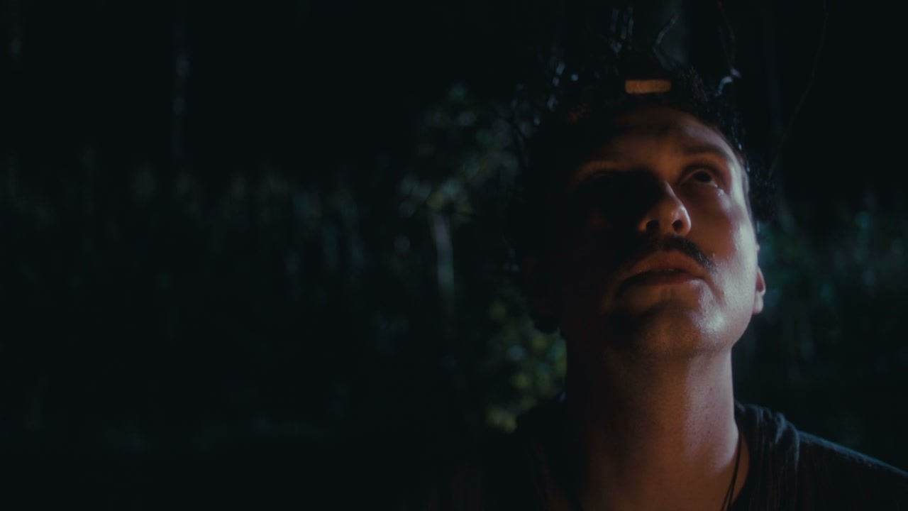 Man with Headpiece Looking Up at Night