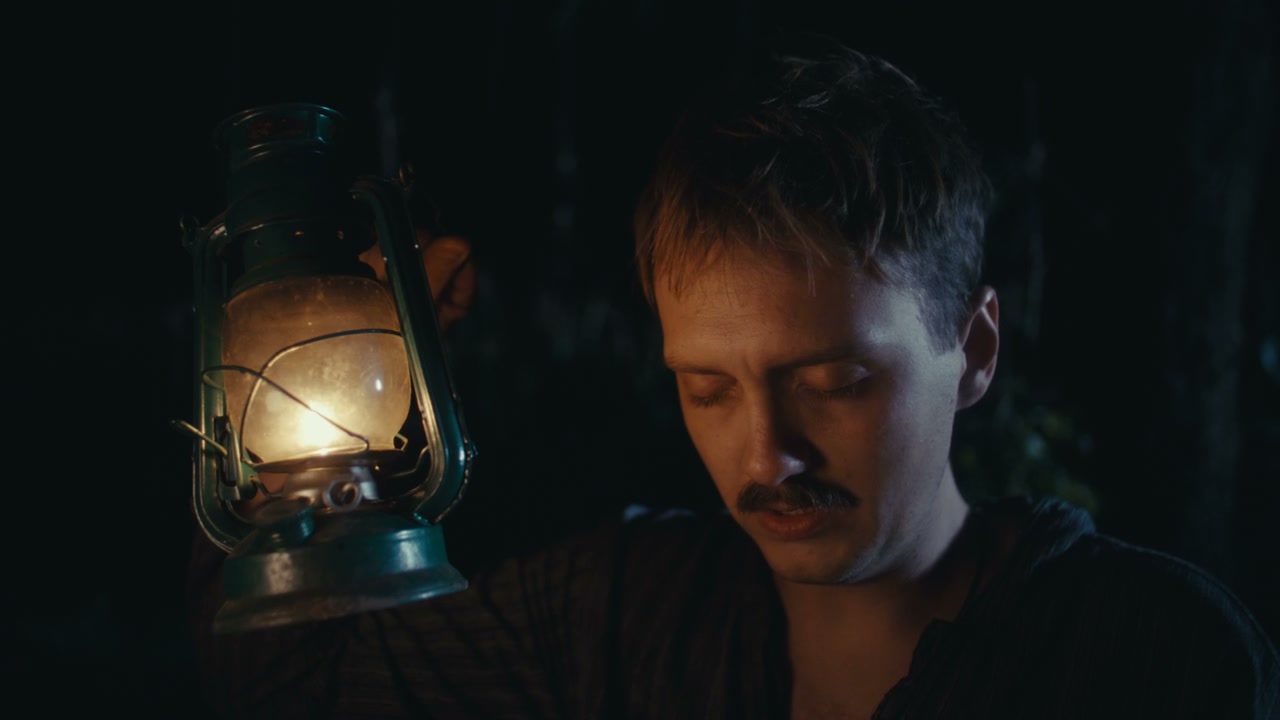 Man Holding Old Lantern at Night