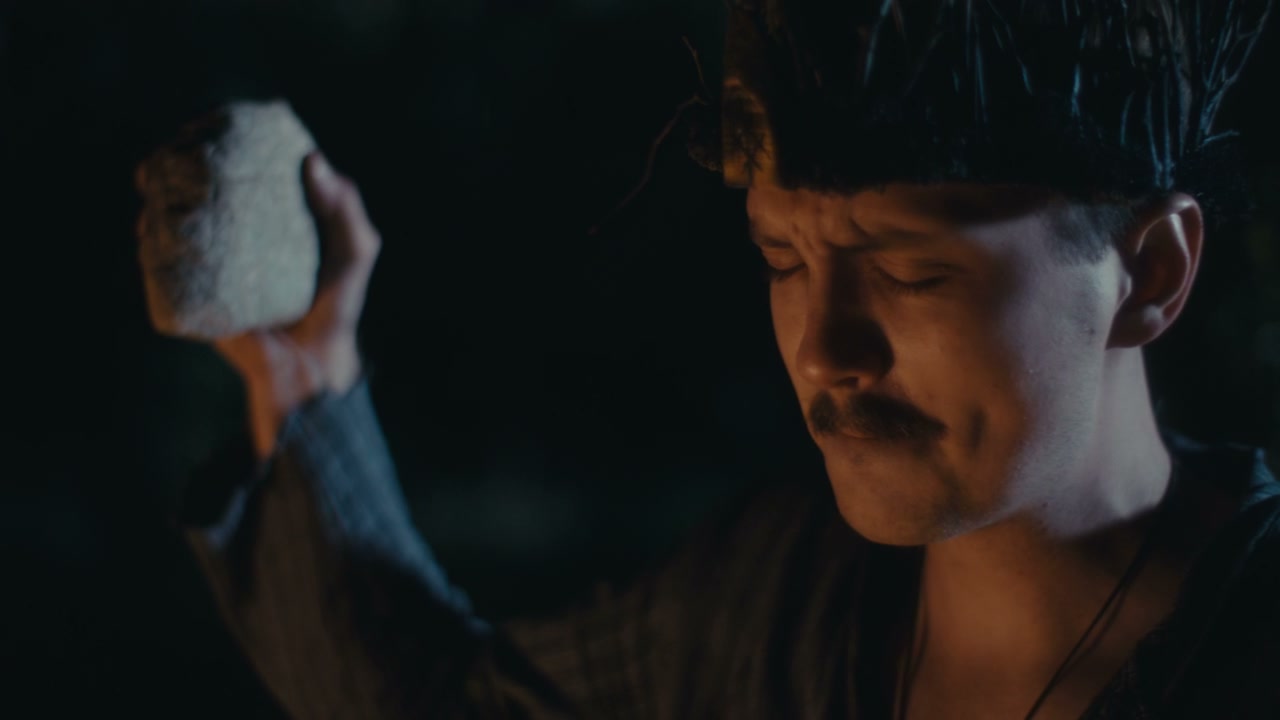 Person Performing Ancient Ritual at Night